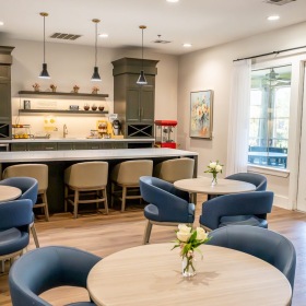 Find your perfect fit at Azalea Trails Assisted Living & Memory Care a dining hall with blue chairs